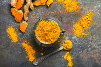 Curcumin powder on a surface and in a spoon
